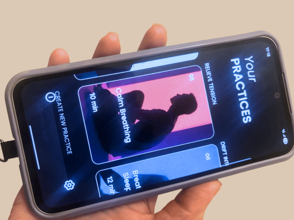 A hand holding a mobile phone, displaying the Aeri App